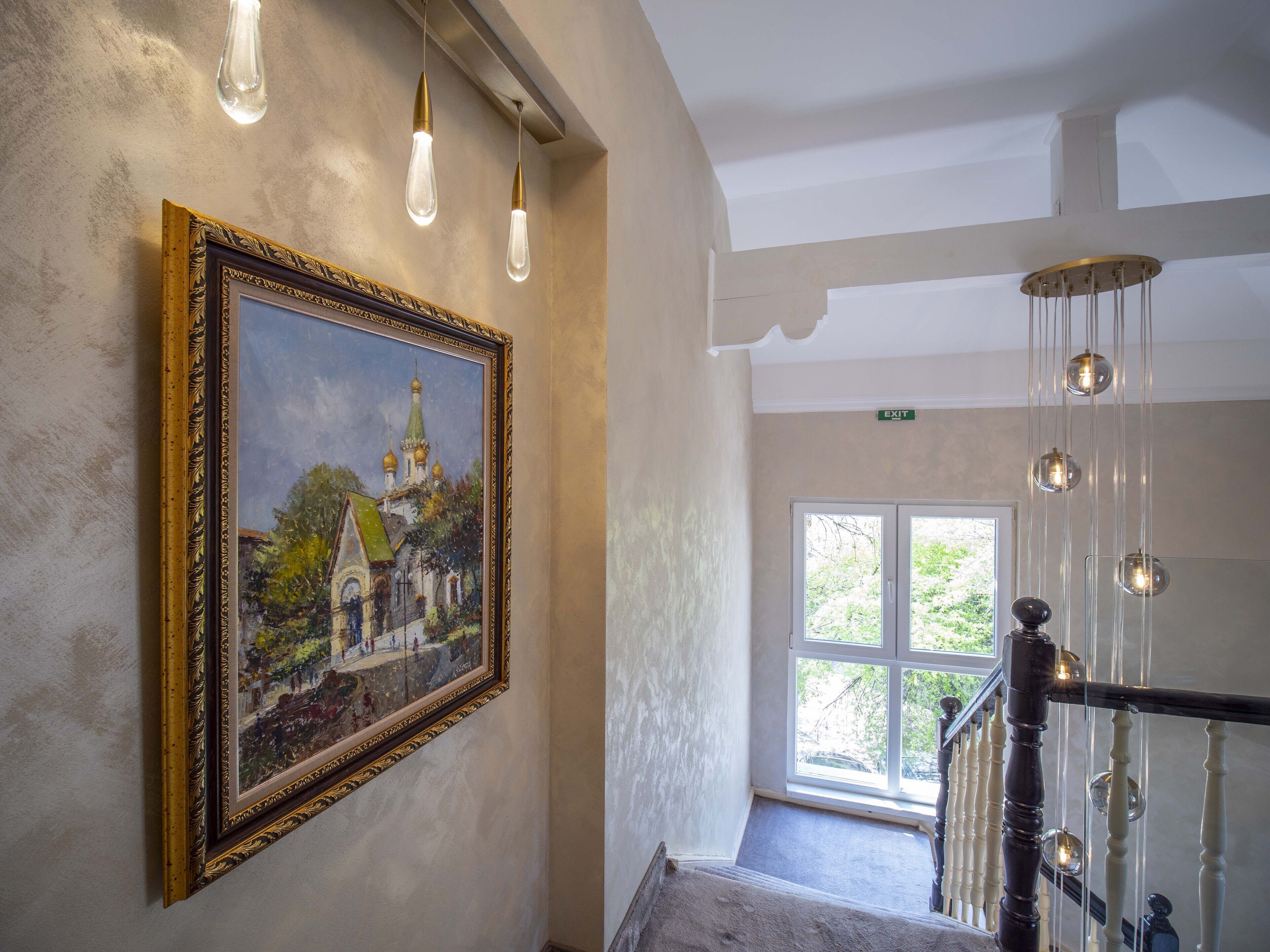 A staircase with a wooden handrail and a glass door leading outside.