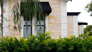 A modern building with stone facade and black awning over a window. - Sandstone Villa In City Fringe Location (Fullarton)
