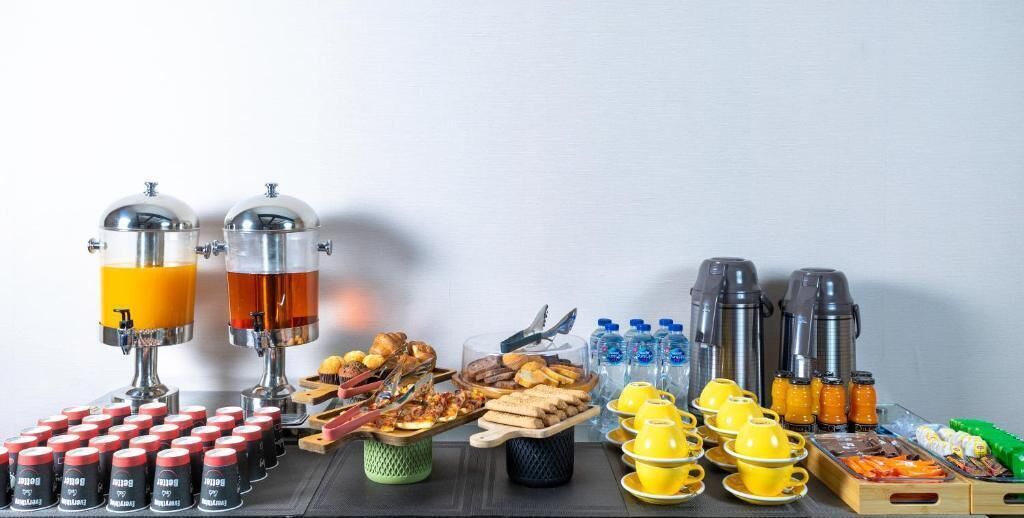 A breakfast buffet with various food items and beverages.