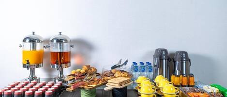 A breakfast buffet with various food items and beverages.