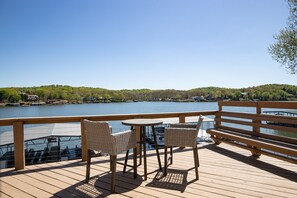 Stunning outdoor deck with breathtaking view of the lake perfect for gathering. - Ultimate Waterfront Getaway, Amazing Lake View (Climax Springs)