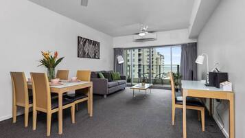 Executive Apartment | Living area | 40-inch Smart TV with cable channels, TV, Netflix