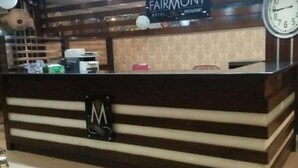 A reception desk with a sign that reads "FAIRMONT HOTEL." - Fair Mont (Multan)