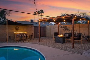 Relax by the pool and enjoy outdoor dining or socializing under the pergola.