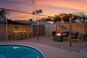 Relax by the pool and enjoy outdoor dining or socializing under the pergola.