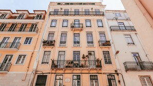 A multi-story building with balconies, large windows, and a traditional architectural style.