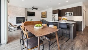 A modern kitchen with dark wood cabinets, a stainless steel refrigerator, and a built-in microwave. - River West 924 - Silverthorne Condo with River Views. (Silverthorne)
