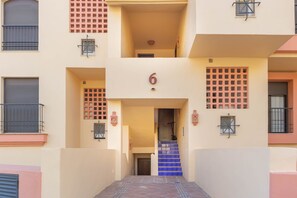 A multi-story building with a central staircase leading to an upper floor.