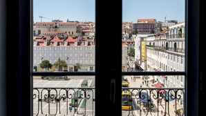 A view from a window overlooking a cityscape with buildings and a tram. - Master Deco Gem in Baixa (Lisboa)