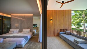 A modern bedroom with a large bed, a sofa, and a balcony with a wooden railing. - Villa De Time The Luxury Private Pool Villa (Pattaya)
