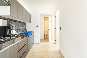 Fridge, microwave, coffee/tea maker, cookware/dishes/utensils