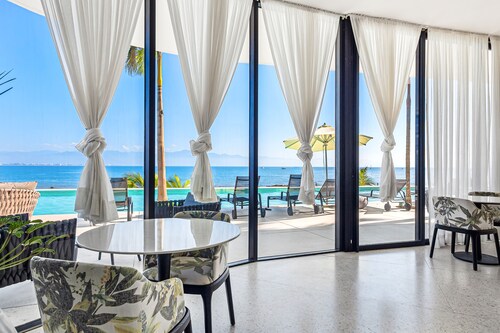 3rd-floor beachfront condo with ocean views, balcony, outdoor pool, gym, & AC