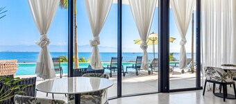 3rd-floor beachfront condo with ocean views, balcony, outdoor pool, gym, & AC