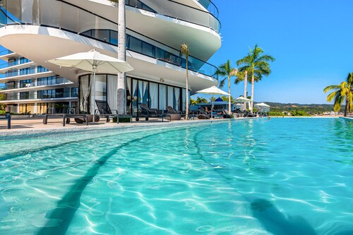 3rd-floor beachfront condo with ocean views, balcony, outdoor pool, gym, & AC