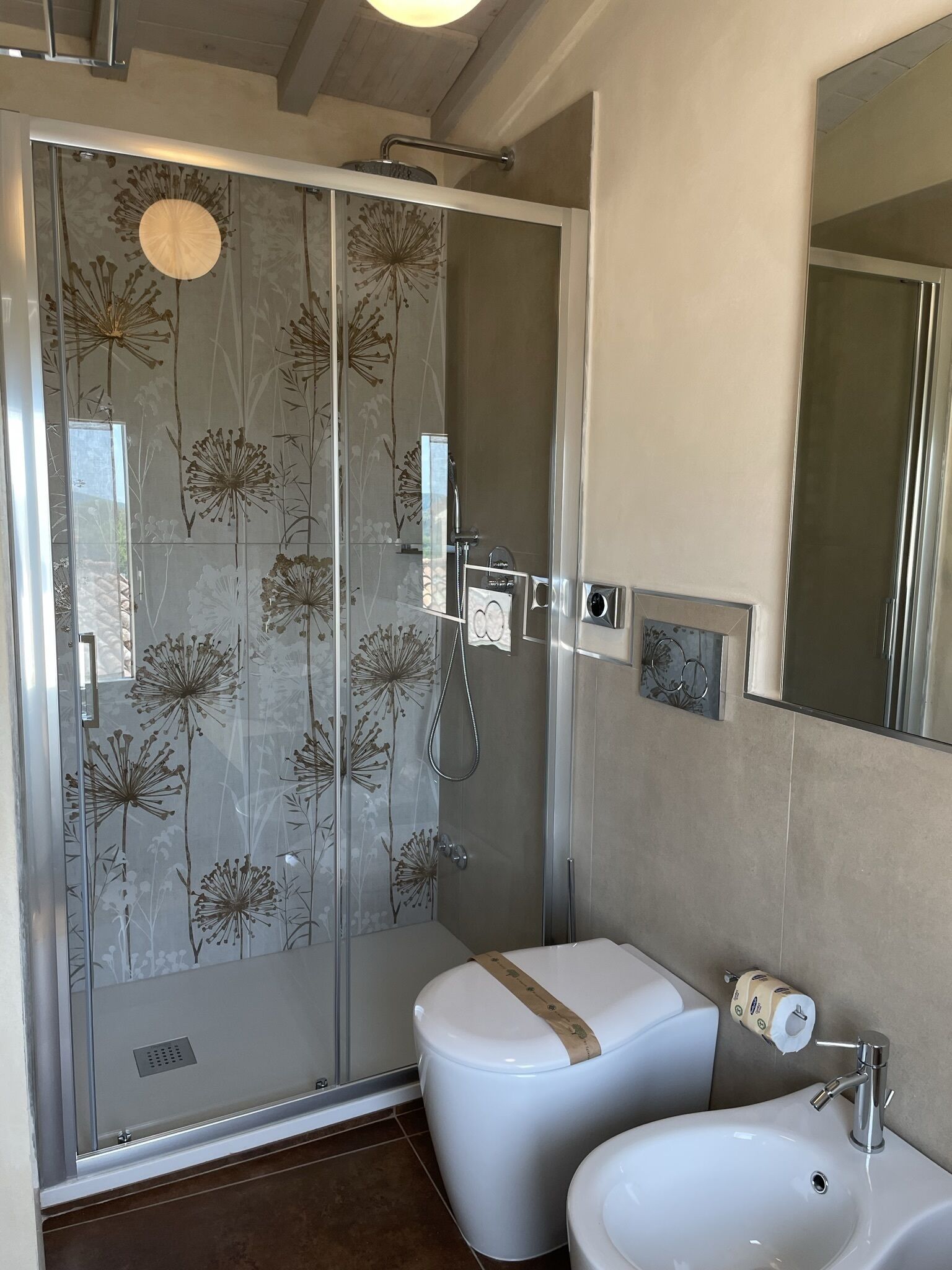 A bathroom with a shower, toilet, and sink.
