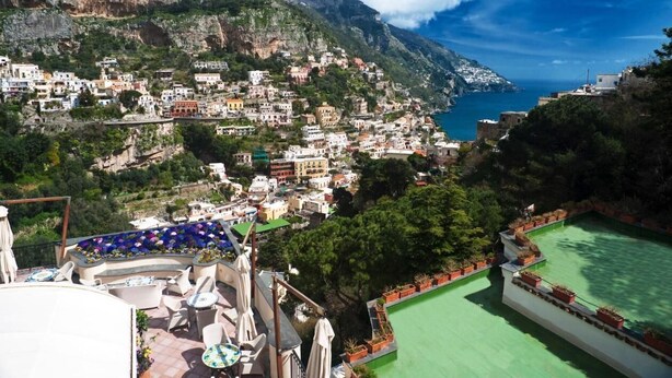 A coastal town with buildings on a hillside overlooking the sea. - Splendid Suite with Sea View Terrace  (Positano)