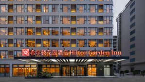 A multi-story hotel with a prominent sign for Hilton Garden Inn. - Hilton Garden Inn Guangzhou Airport Aerotropolis (Guangzhou)