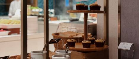 A breakfast buffet with various food items and condiments.