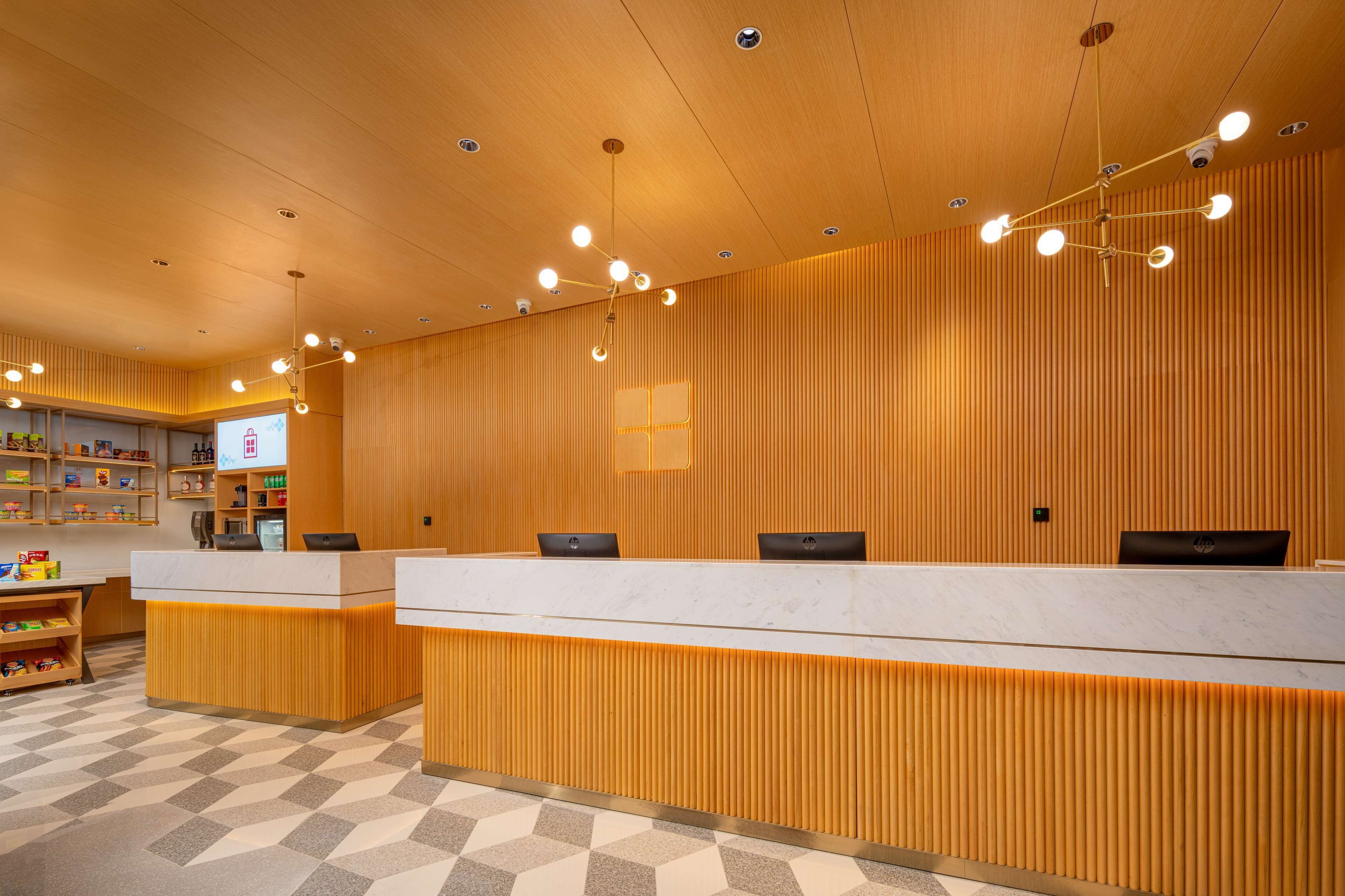 A reception area with a wooden reception desk, multiple computer stations, and a children's play area.