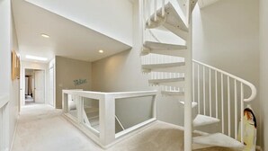 A spacious hallway with a white staircase leading to a landing. - Walk to Village/Beach/A/C/EV Charger/Parking (La Jolla)