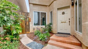 A house with a front door, a small garden with plants and a pathway, and a wooden fence. - Walk to Village/Beach/A/C/EV Charger/Parking (La Jolla)