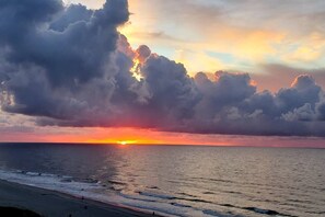 A sunset over the ocean with clouds. - 🏴‍☠️Pirate Ruby's Oceanfront End Unit | Sleeps 10 | Walk to Main St | Pack Less (North Myrtle Beach)
