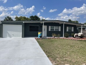 Enjoy a peaceful stay in this single-story home with a well-maintained lawn and driveway.