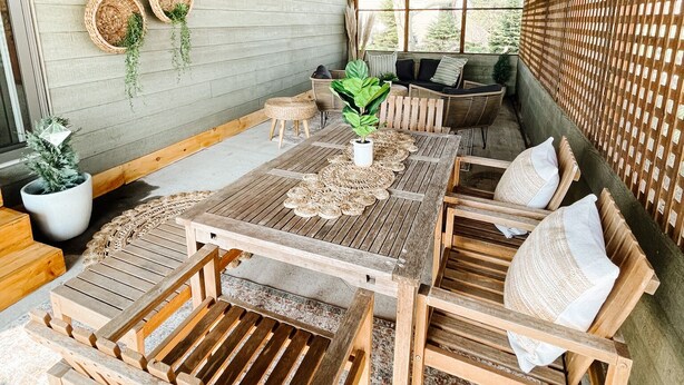 A wooden dining area with a table, chairs, and a ceiling fan.