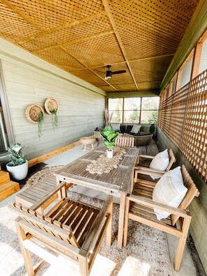 A wooden dining area with a table, chairs, and a ceiling fan. - Short Drive to Point Pelee! Forget Your Worries in This Spacious & Serene Space (Leamington)
