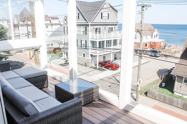 Enjoy lounging after a long beach day on the sectional looking out at the water