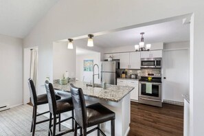 Fridge, dishwasher, coffee/tea maker, cookware/dishes/utensils