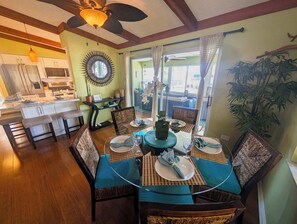 A dining area with a round table, chairs, and a view of the kitchen and dining room. - Delightful vacation home located in the popular Islamorada neighborhood of Port Antigua. (Islamorada)