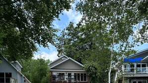 A two-story house with a stone pathway leading to the front door. - Loons Landing - Relax on the lake, your perfect Traverse City retreat. (Traverse City)