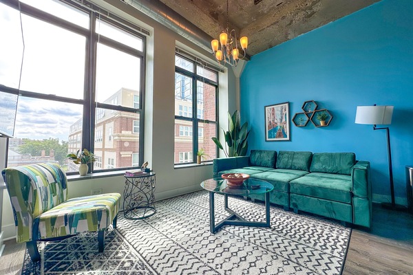 Spacious living room with a lot of natural light and large windows.