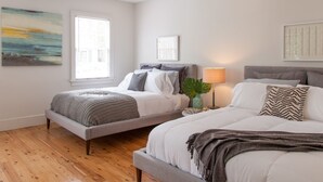 A bedroom with two beds, a window, and artwork on the walls. - 5 Queen Beds, Downtown, Park in Private Driveway, Stroll to Charleston's Best (Charleston)