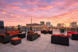 A rooftop terrace with outdoor seating, string lights, and a city skyline view. - McCormick Place Studio with optional parking for up to 4 guests (Chicago)