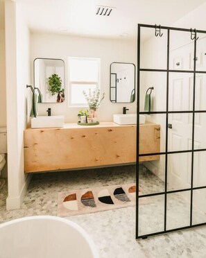 Bathtub, hair dryer, shampoo, toilet paper