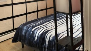 A bedroom with a bed, a window, and a ceiling light fixture. - Stockade Japanese Ryokan, King bed, Washer/Dryer (Schenectady)