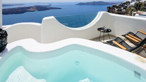 A pool with a view of the sea and a white building with a balcony. - Located at the breathtaking caldera of Imerovigli (Ημεροβίγλι)