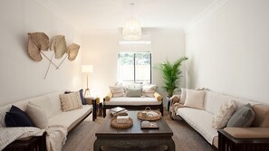 A living room with two sofas, a coffee table, a lamp, and decorative items.