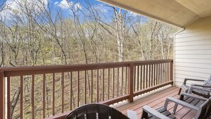 A wooden deck with a railing, overlooking a forested area. - Two in One! Condo & Suite with Lock-off Connecting Access (Reeds Spring)