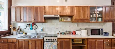 Full-size fridge, stovetop, toaster, cookware/dishes/utensils