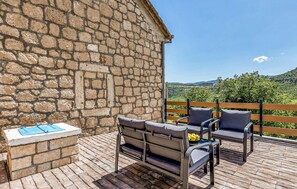 Relax on the furnished terrace with a view of the lush landscape.