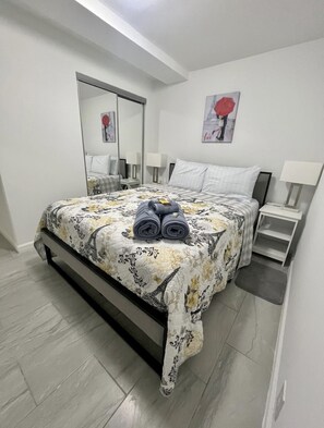 Comfortable accommodations feature a large bed, nightstand, and mirror.