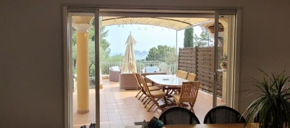 Enjoy dining or socializing in the outdoor patio area with a round table and comfortable seating.