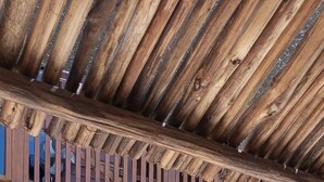 A wooden building with a balcony, a staircase, and a small garden area. - El Regalo El Cuyo (El Cuyo)