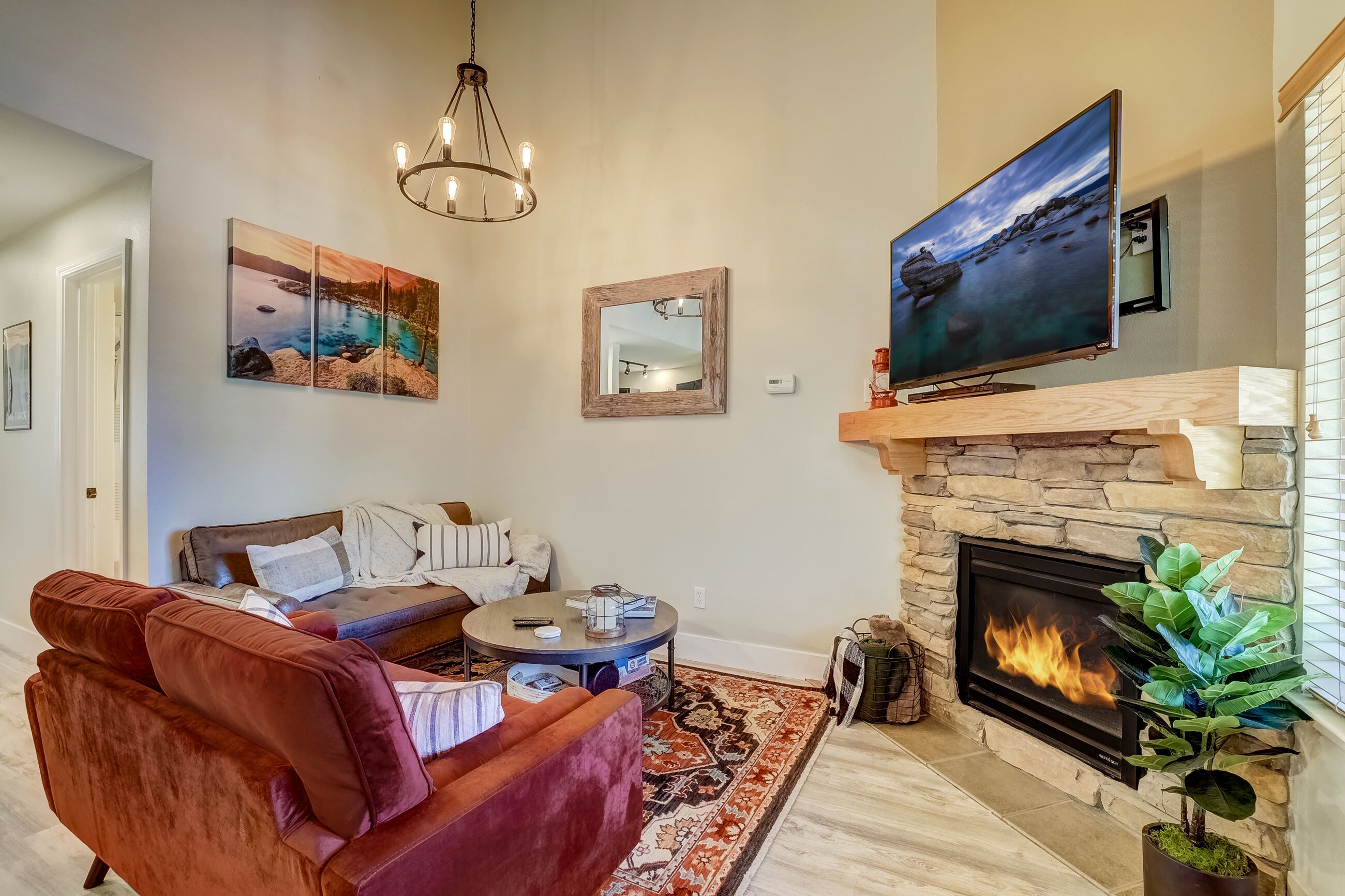 A living room with a fireplace, a television, and a sofa.
