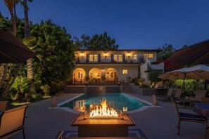 A two-story house with a swimming pool and a fire pit in the foreground. - Villa San Michelle with a pool! (Vista)