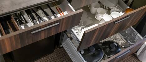 A kitchen with wooden cabinets, stainless steel appliances, and a marble countertop.