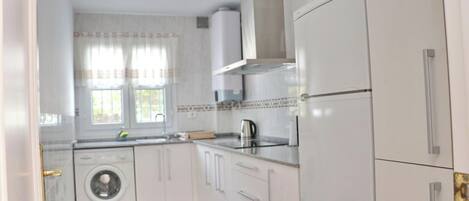 Fridge, microwave, coffee/tea maker, cookware/dishes/utensils